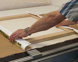 Paul stretches canvas by machine