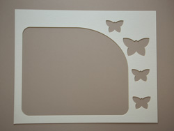 A mat with an opening and 4 butterfly cliparts