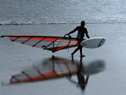 A wind surfer takes a chilly dip