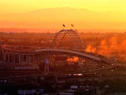 The Fremont Bridge built in 1973 and flags; sunrise, Portland Oregon