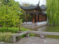 Pond surrounding Painted Boat in Misty Rain