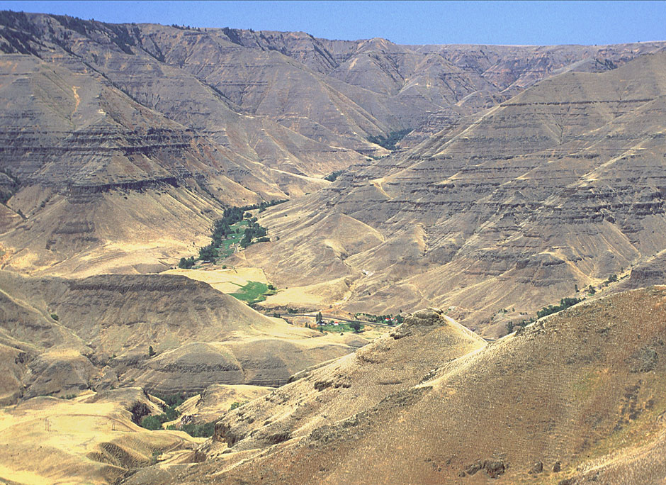 a ranch dwarfed by the huge hills of Imnaha Canyon