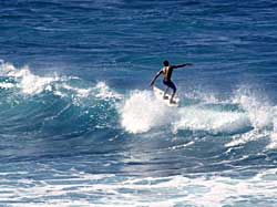 Suntan boy surfing in Maui, Hawaii