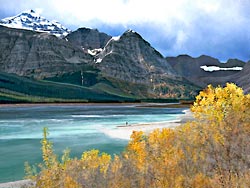 Fisherman Dwarfed by the Sherburne Rockies in Glacier National Park