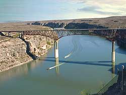 Big Bend, Texas: Boaters on the Pecos River under Pecos Bridge. Trucks travel to Del Rio